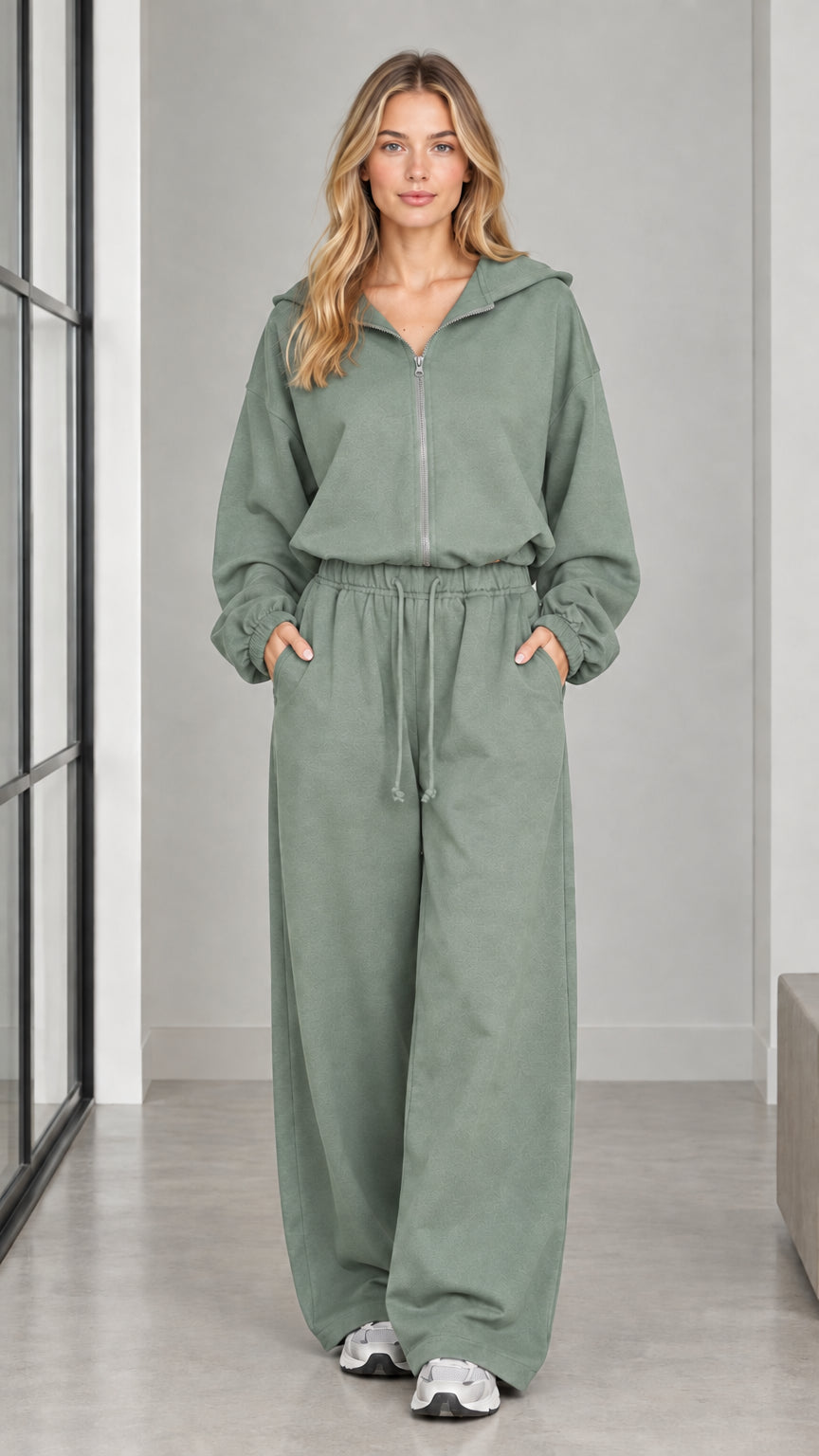 Front full-length view of woman wearing the sage green hooded wide-leg jumpsuit