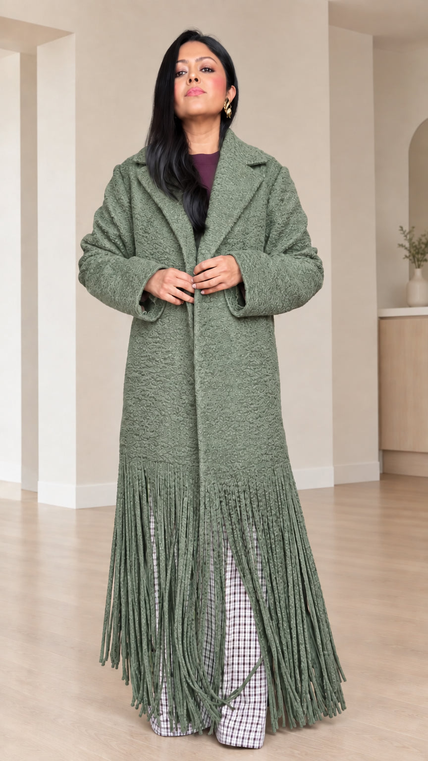 Front view of model wearing Sage Green bouclé fringe maxi coat