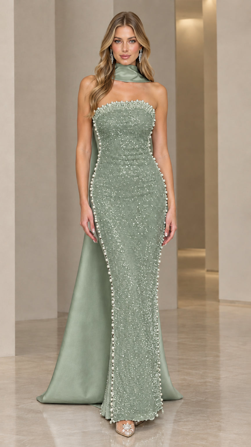 Model wearing sage green sequined evening gown with green cape detail