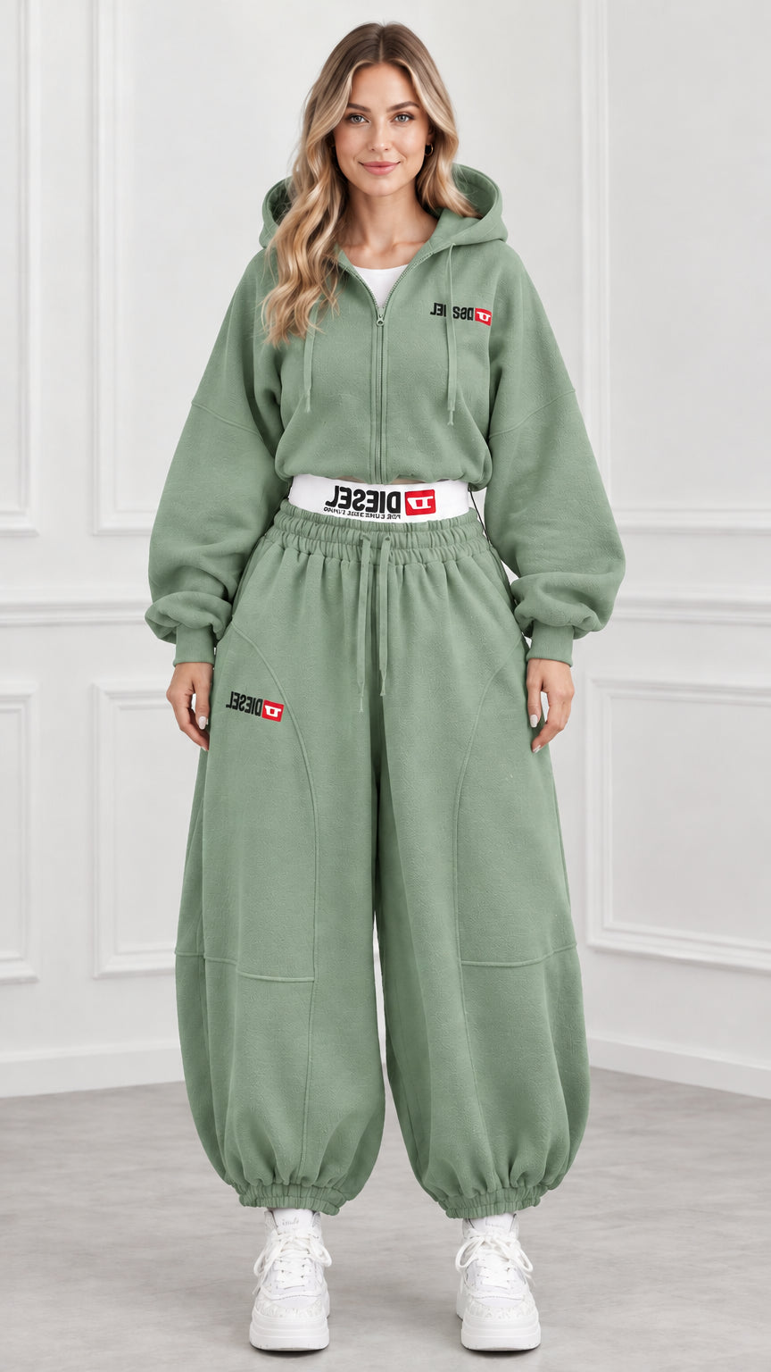 Front view of model wearing sage green cropped hoodie and jogger pants set