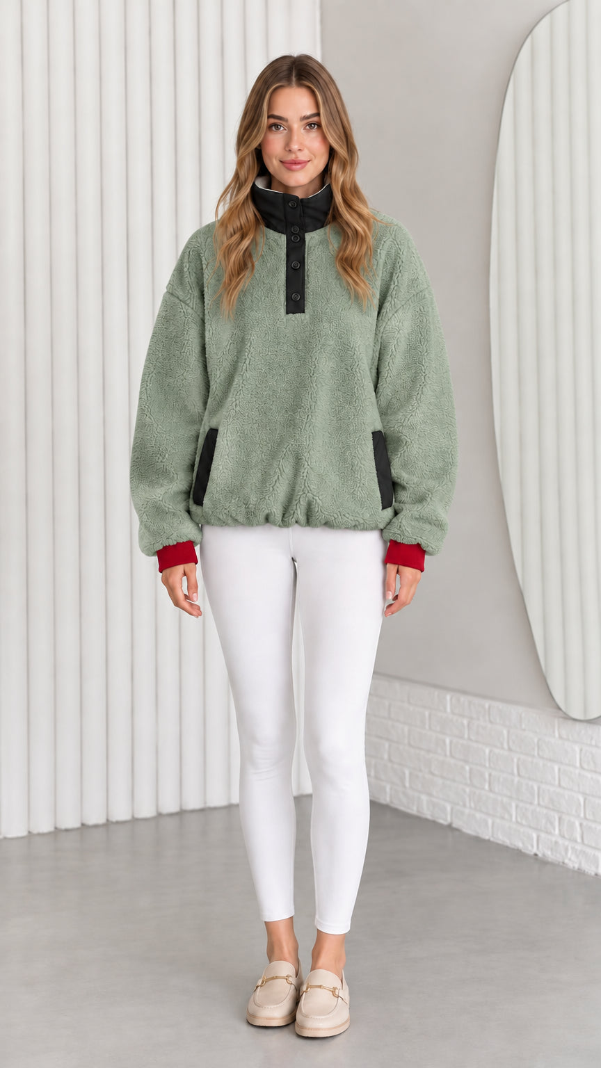 Model wearing sage green sherpa fleece pullover with contrast collar and cuffs