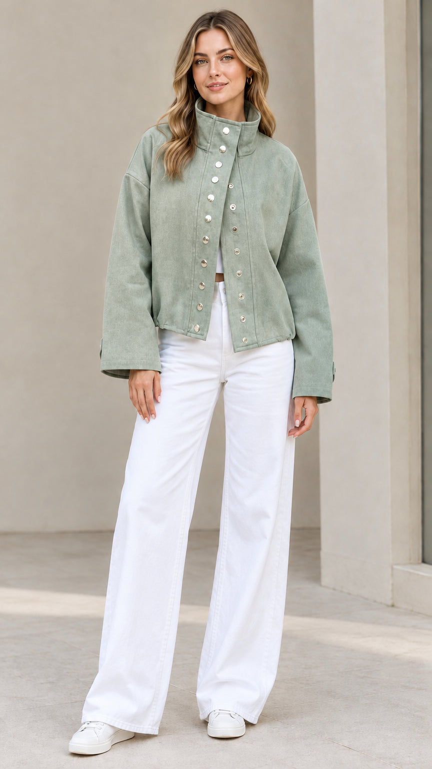 Full-length view of woman wearing Sage Green snap-front utility jacket with white pants