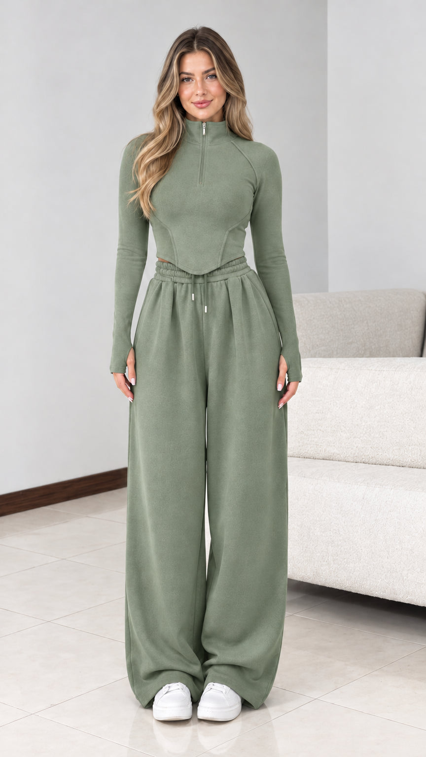 Front view of model wearing sage green half zip wide leg tracksuit