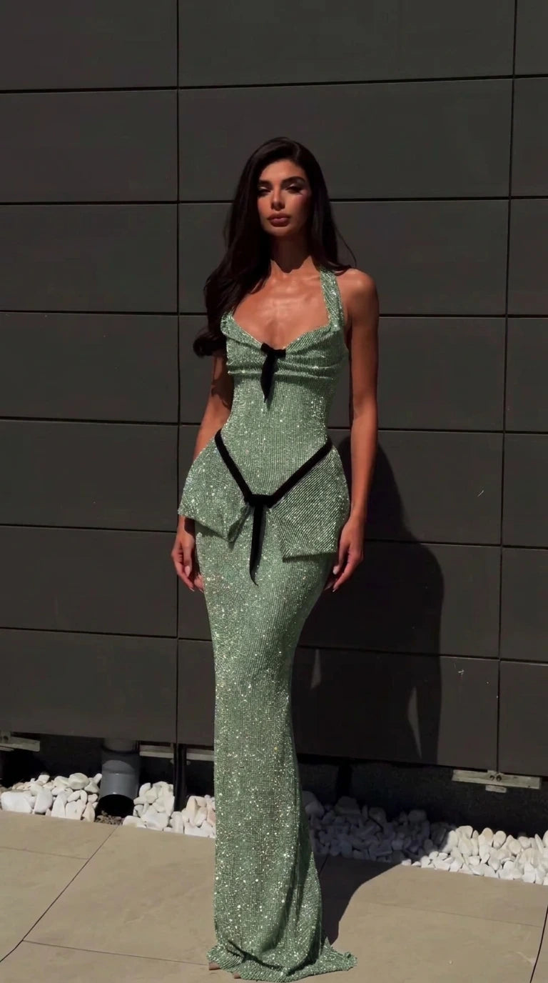 Model wearing sage green glitter halter evening gown with peplum