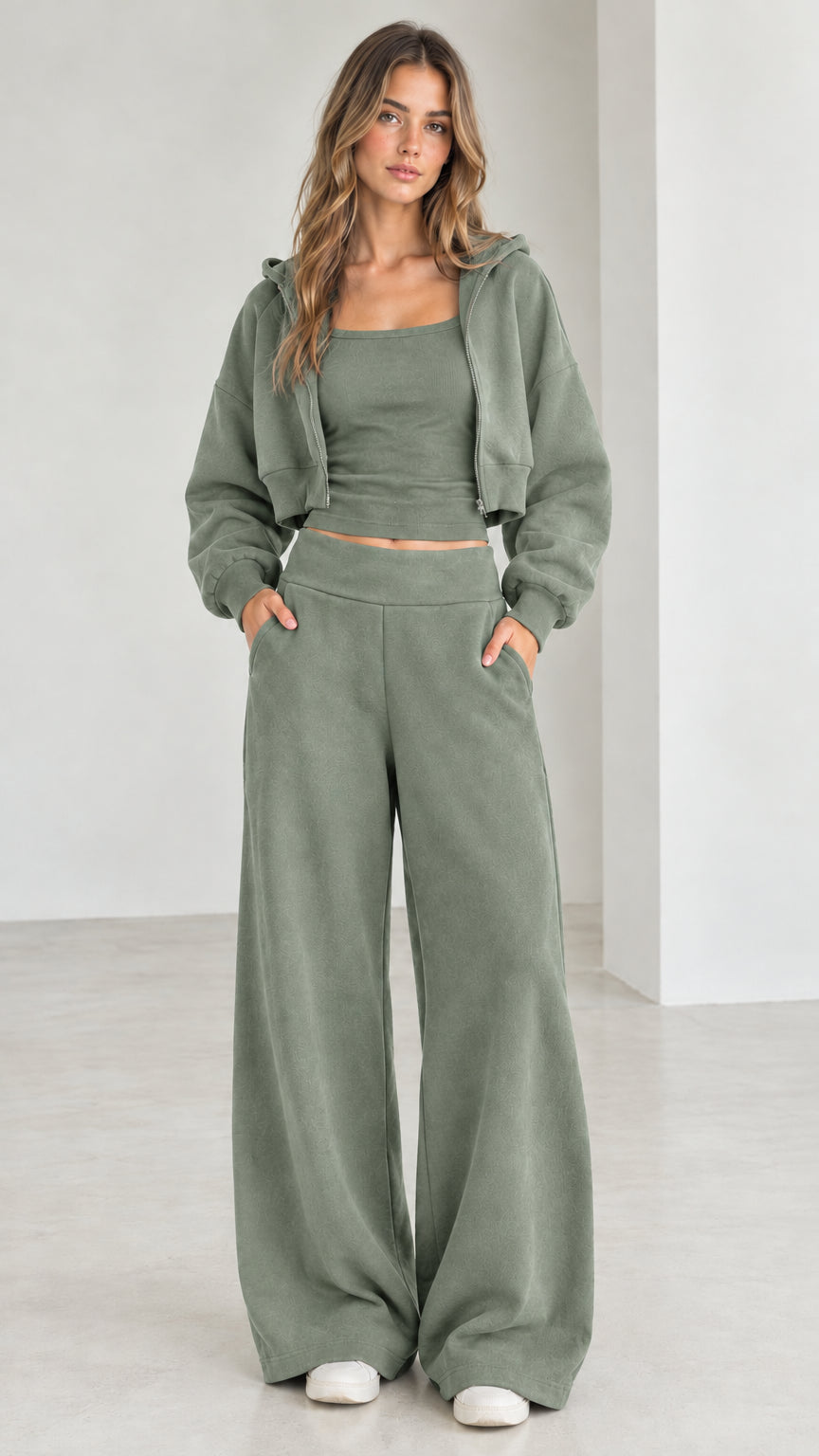 Full front view of model wearing the sage green 3-piece cropped hoodie and sweatpants set