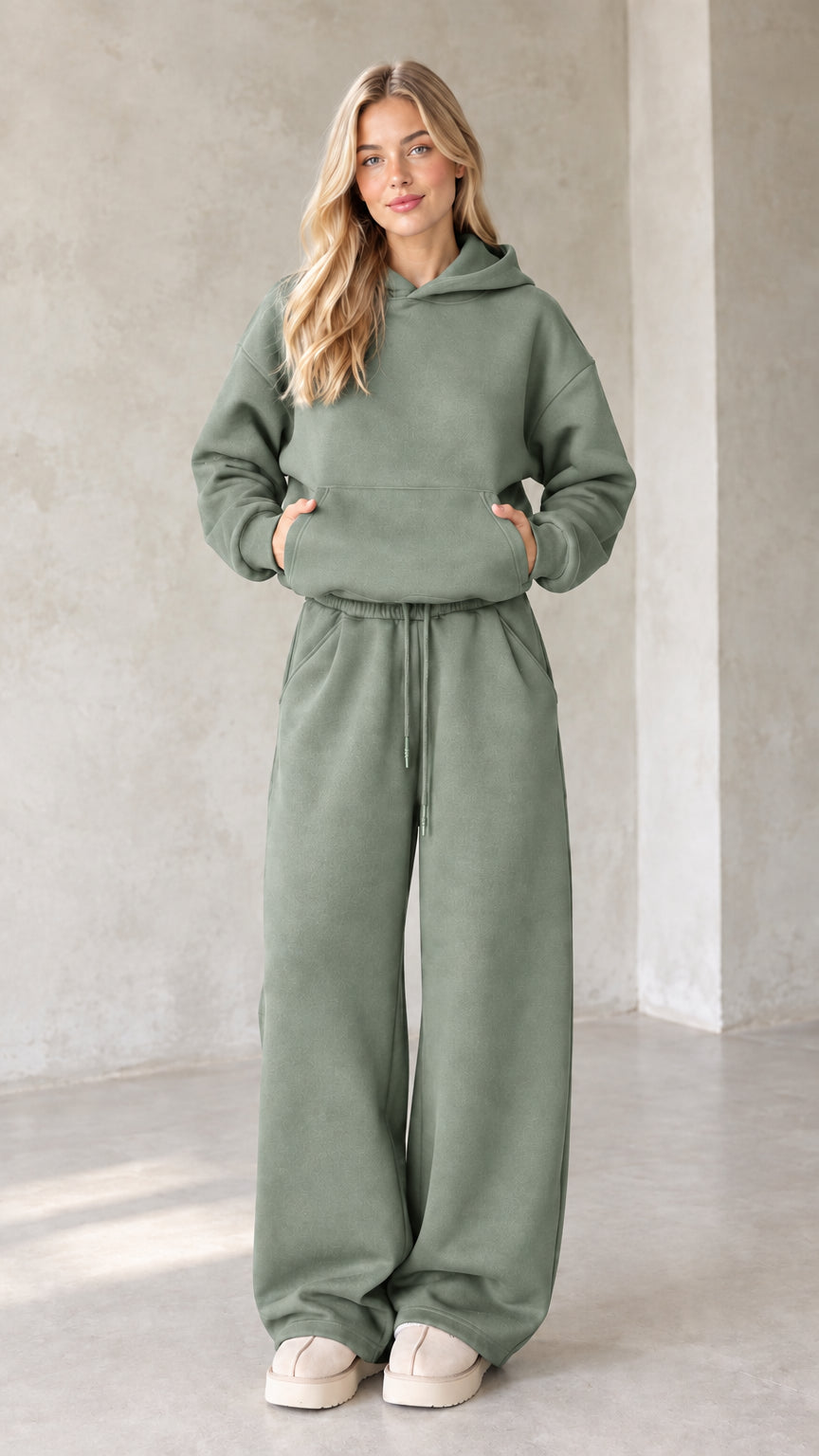 Front view of woman wearing sage green oversized hoodie and wide leg lounge set