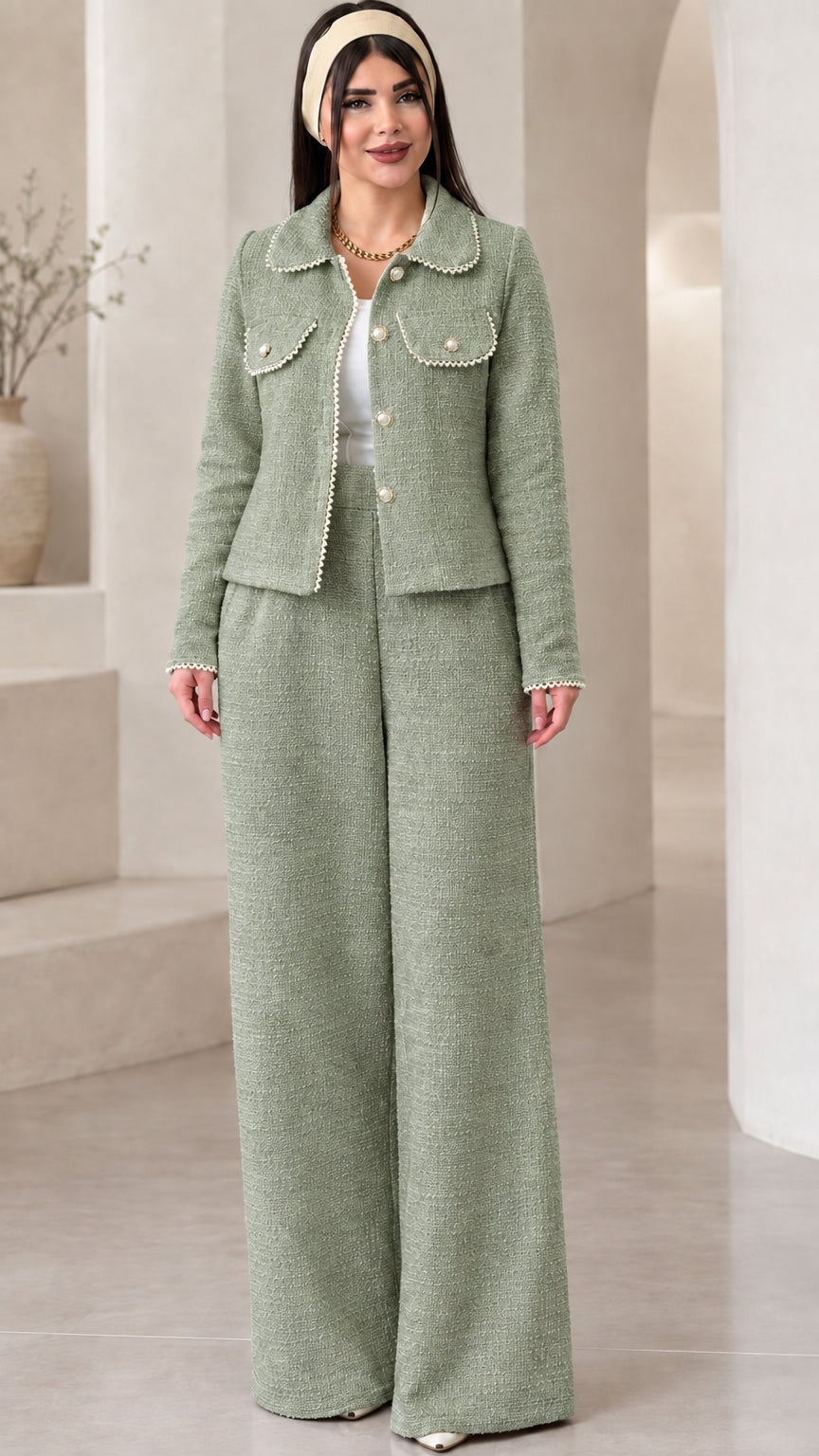 Front view of model wearing the sage green pearl-trimmed tweed jacket and trouser set