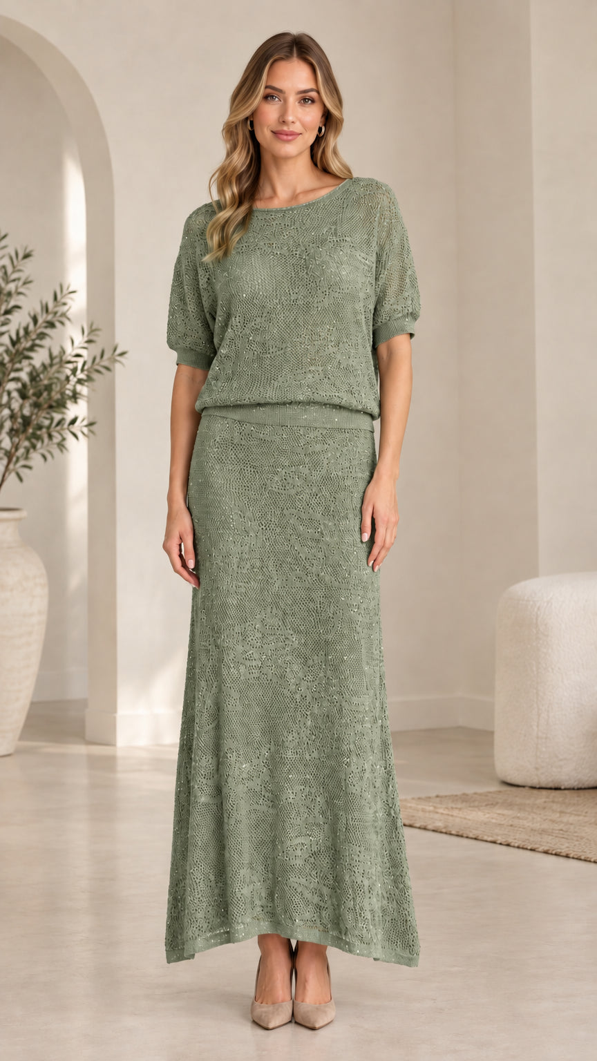 Front view of model wearing sage green sequin knit two-piece maxi skirt set