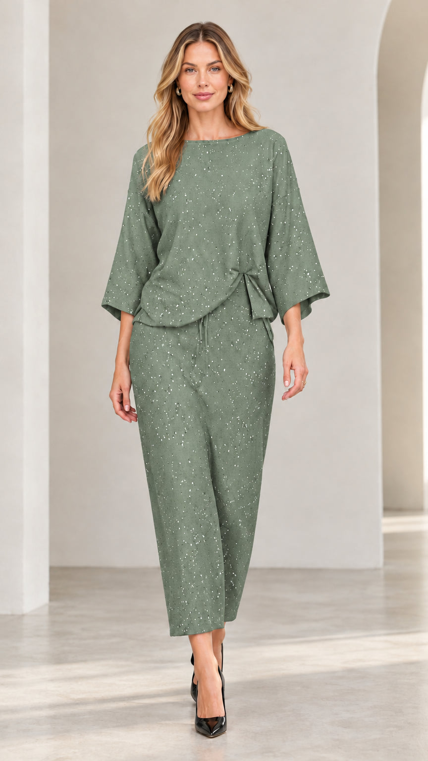 Model wearing sage green shimmer speckled two-piece boatneck top and trousers