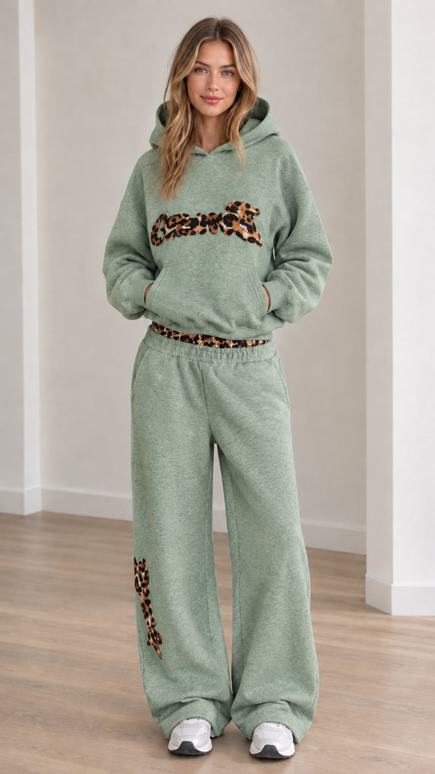 Front view of model wearing the lounge set in Sage Green with animal print detailing