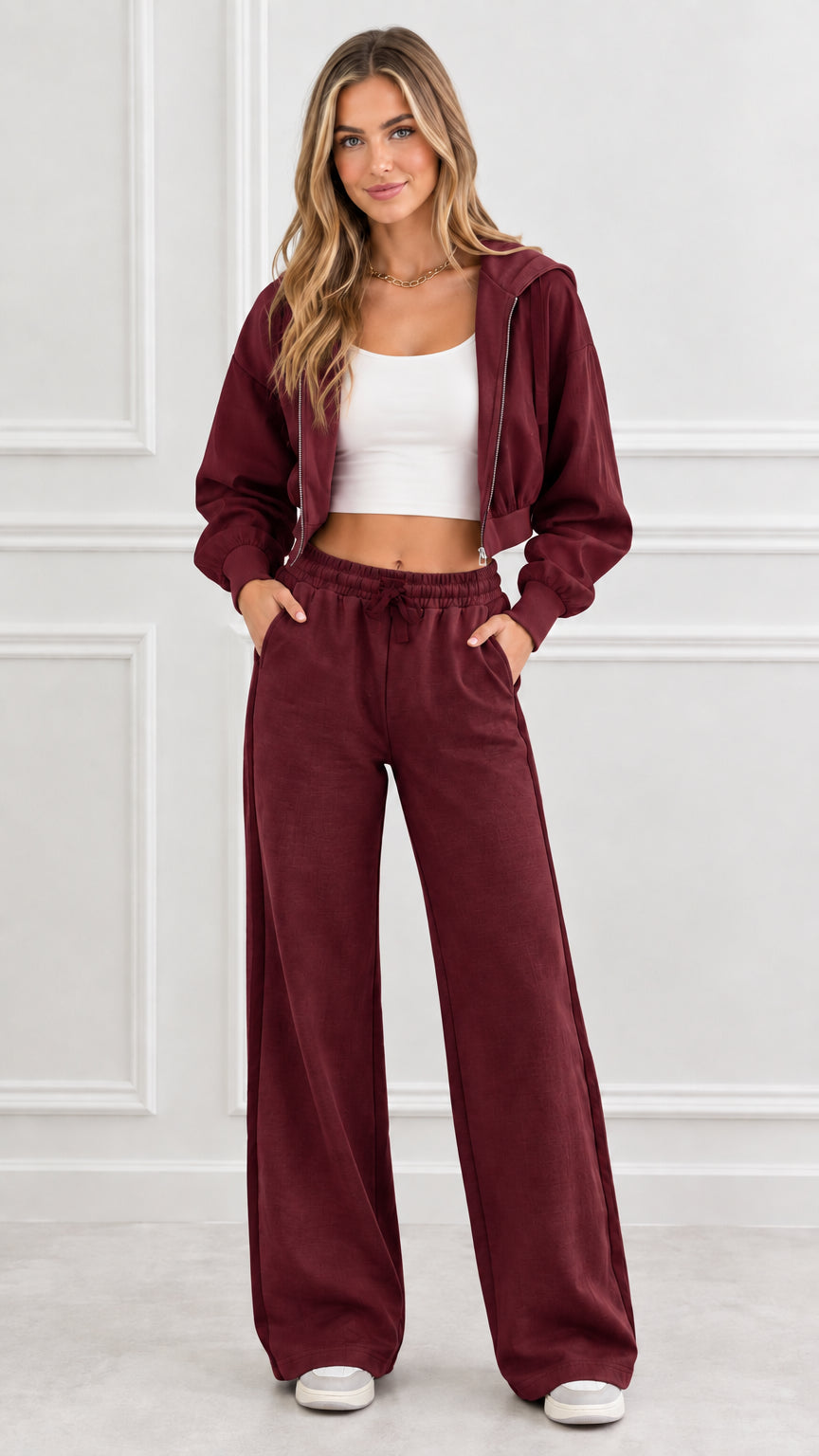 Front view of woman wearing burgundy cropped zip hoodie and matching wide leg sweatpants
