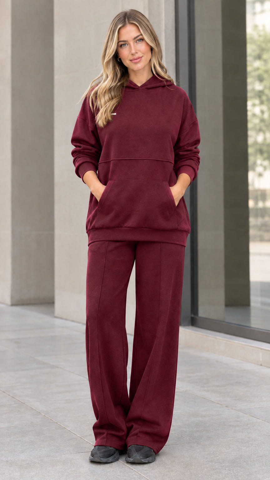 Front view of woman wearing burgundy hoodie and wide-leg sweatpants matching set