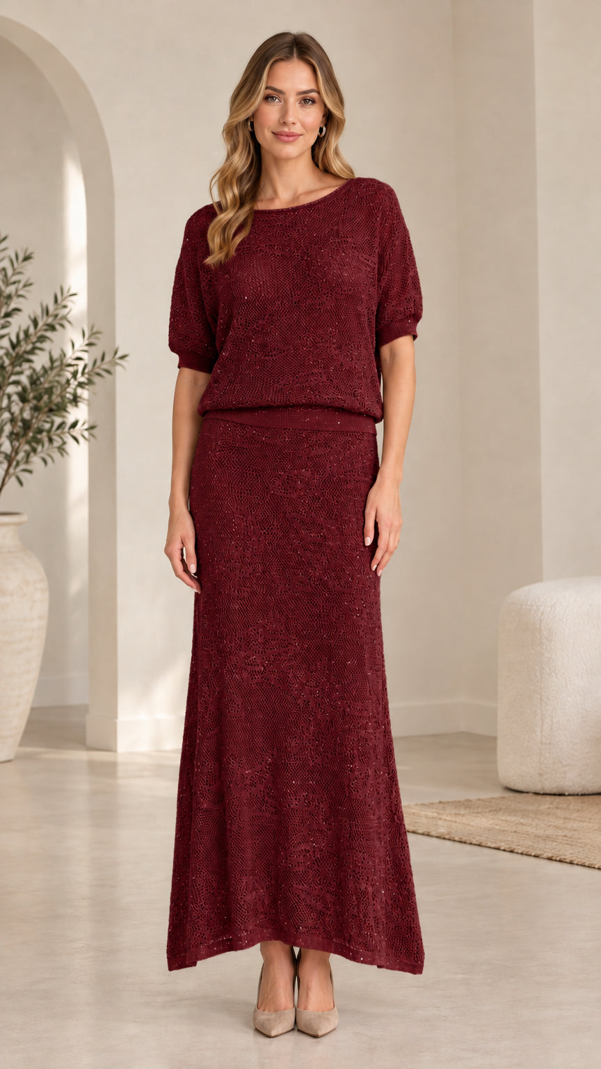 Front view of model wearing burgundy sequin knit two-piece maxi skirt set