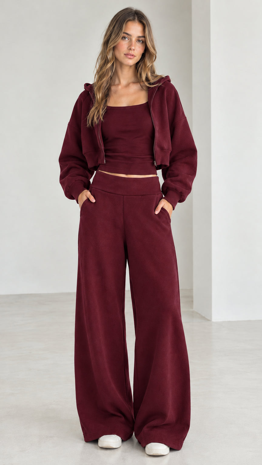Full front view of model wearing the burgundy 3-piece cropped hoodie and sweatpants set