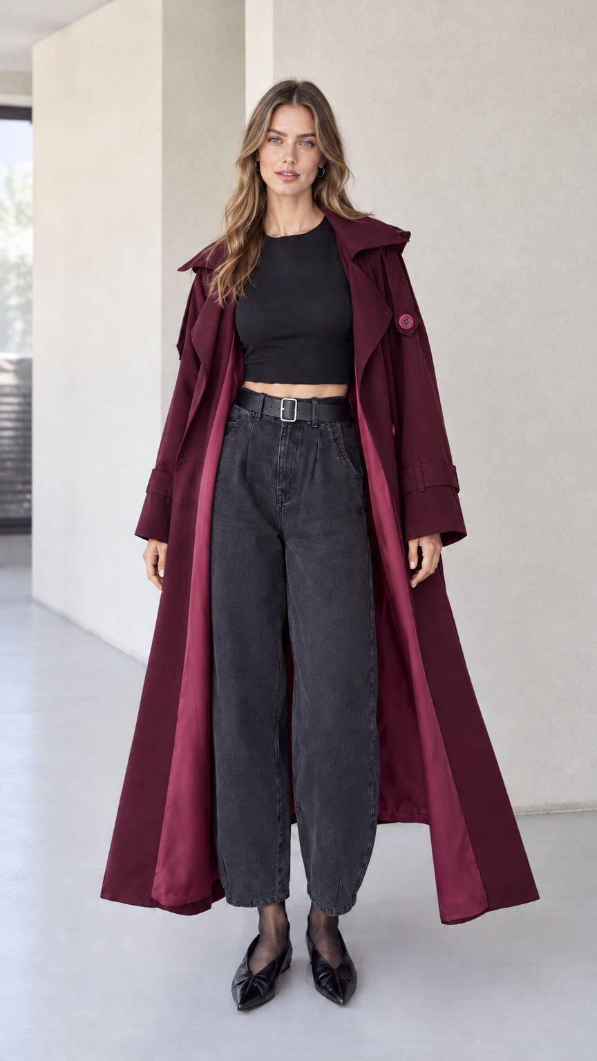 Full front view of burgundy wine red hooded maxi trench coat on model with dark denim