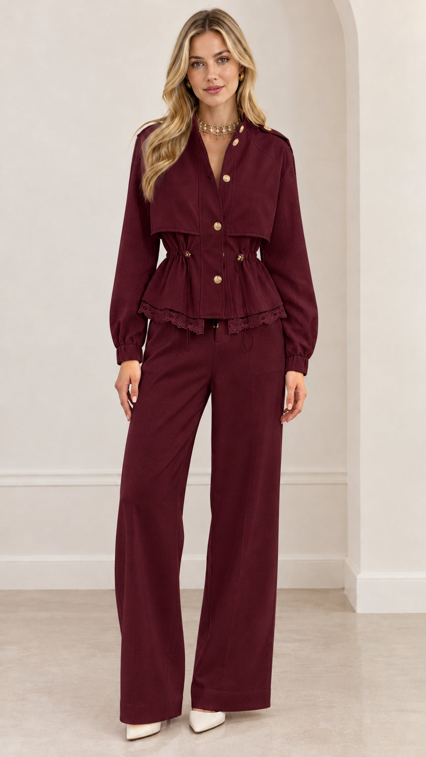 Full-length view of woman wearing burgundy wine red peplum jacket and matching wide-leg trousers