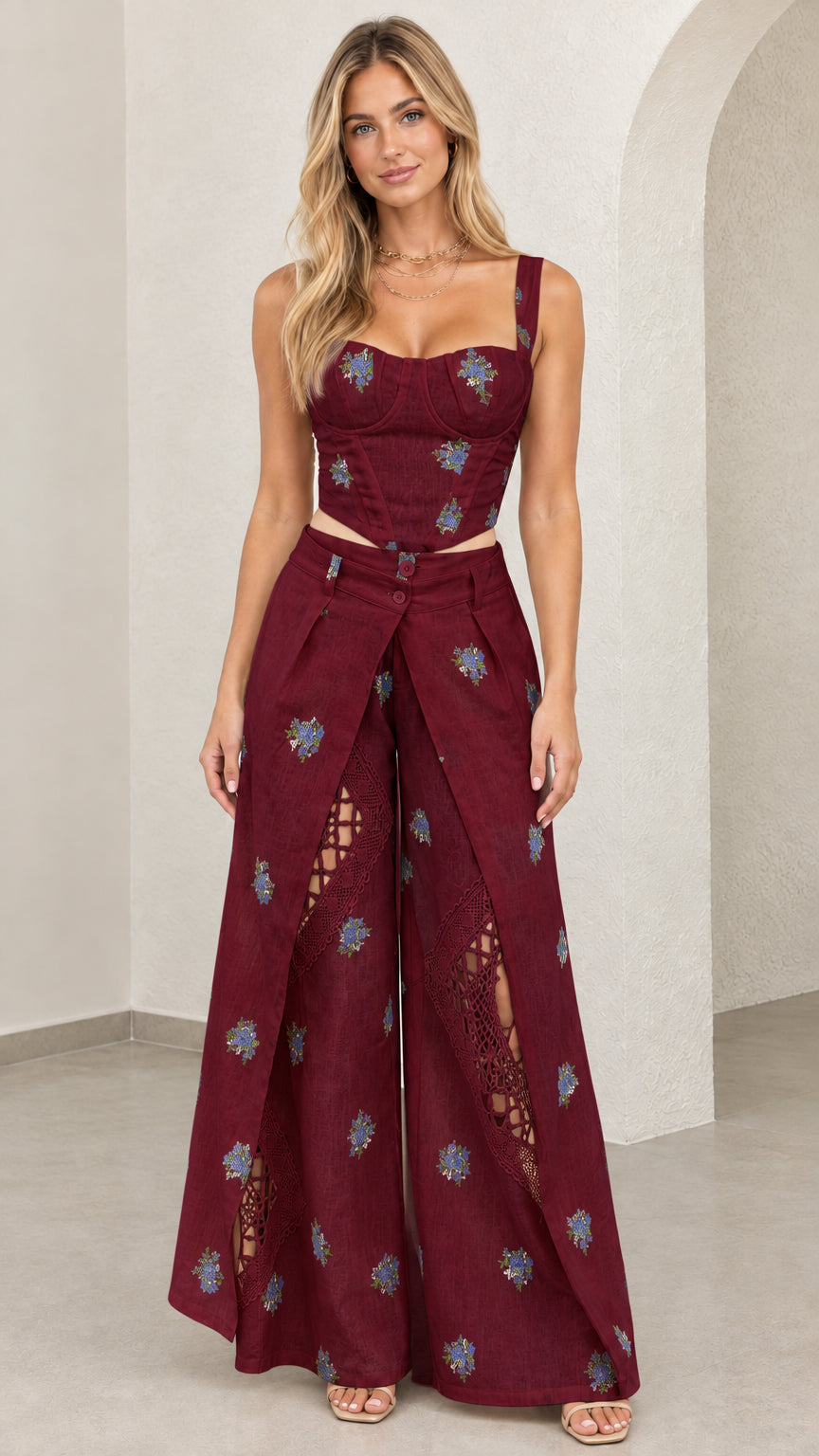 Model wearing burgundy floral embroidered bustier top and wide leg pants set