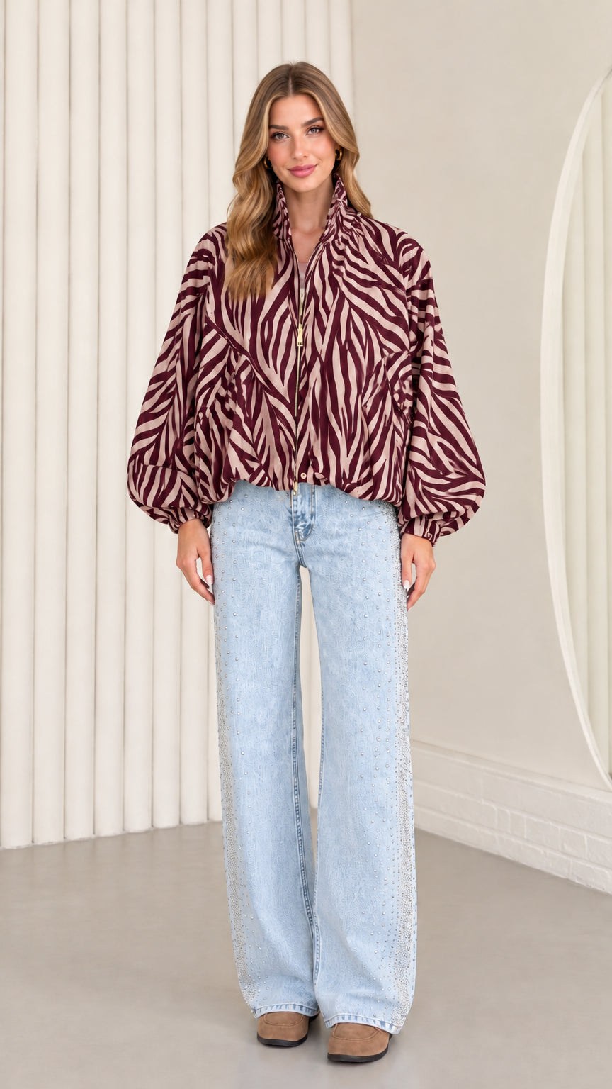 Model wearing rich burgundy zebra print balloon sleeve lightweight jacket