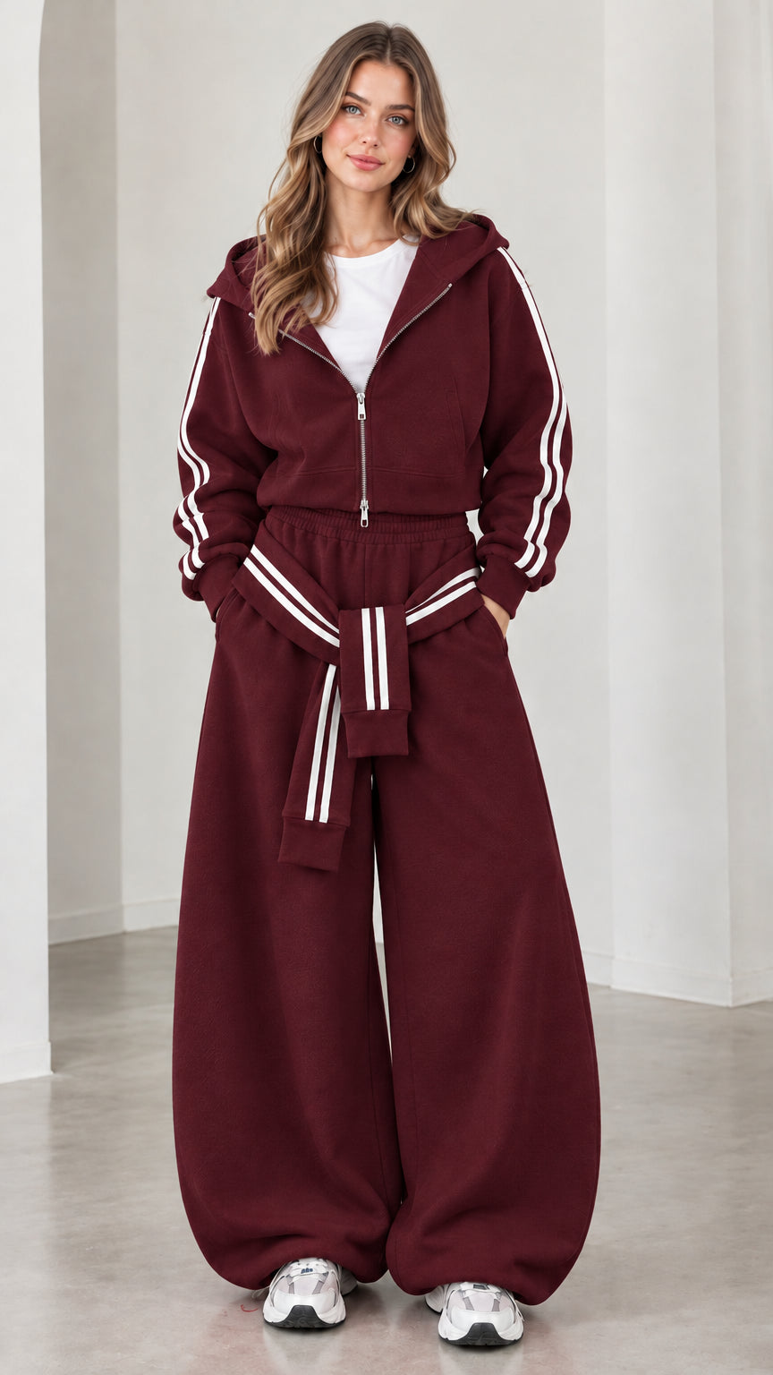 Model wearing burgundy cropped hoodie and wide-leg sweatpants set