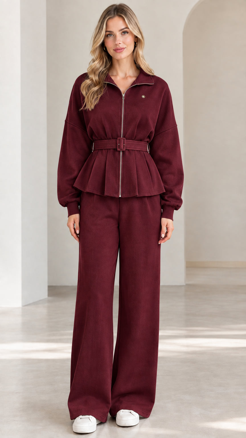 Front full-length view of burgundy red zip-up belted peplum jacket and wide-leg pants set