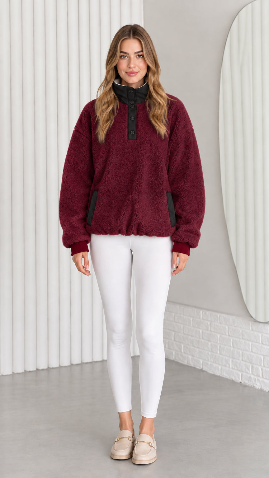 Model wearing burgundy red sherpa fleece pullover sweatshirt