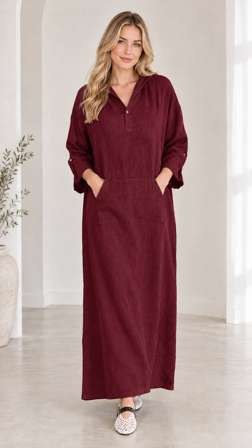 Front view of woman wearing burgundy hooded maxi dress