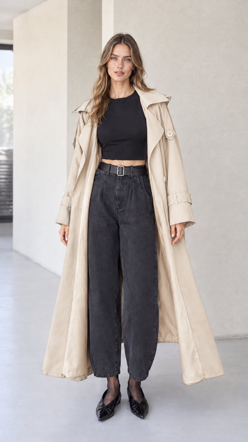 Full front view of beige sand hooded maxi trench coat on model with dark denim