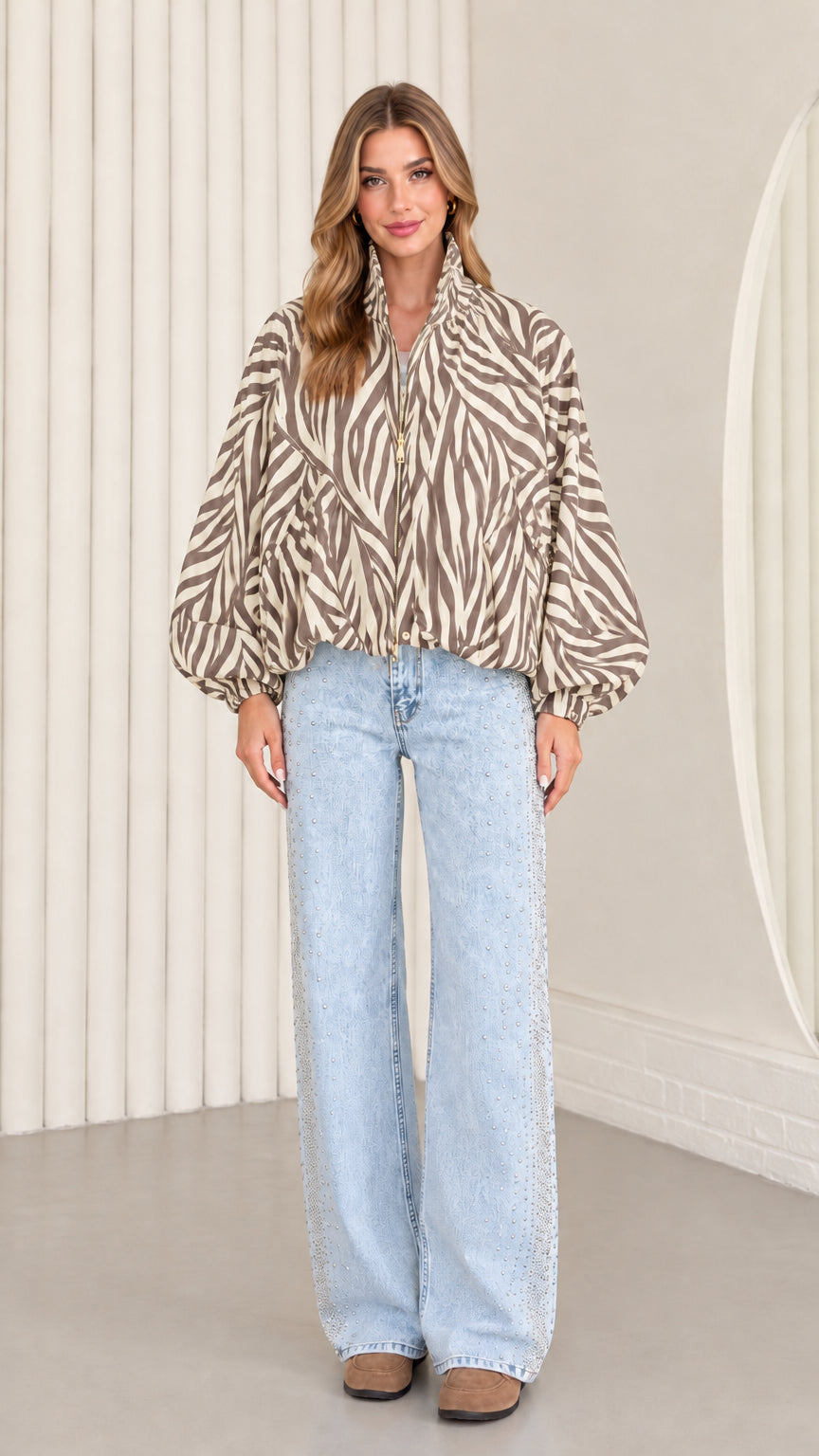 Model wearing taupe beige zebra print zip-up blouson jacket