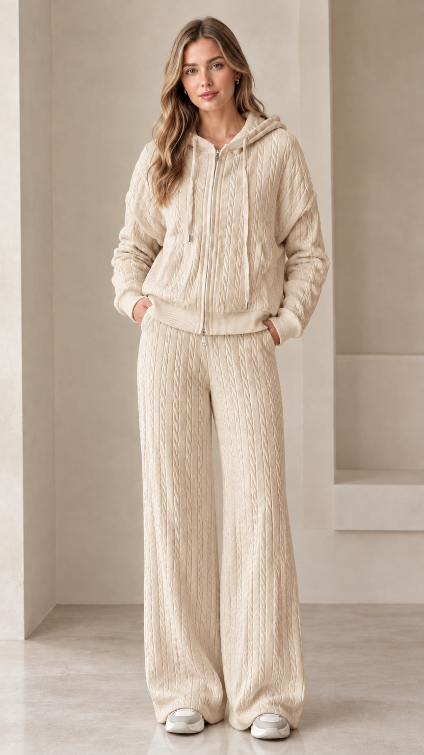 Full-length view of woman wearing beige oatmeal cable knit zip hoodie and wide leg pants