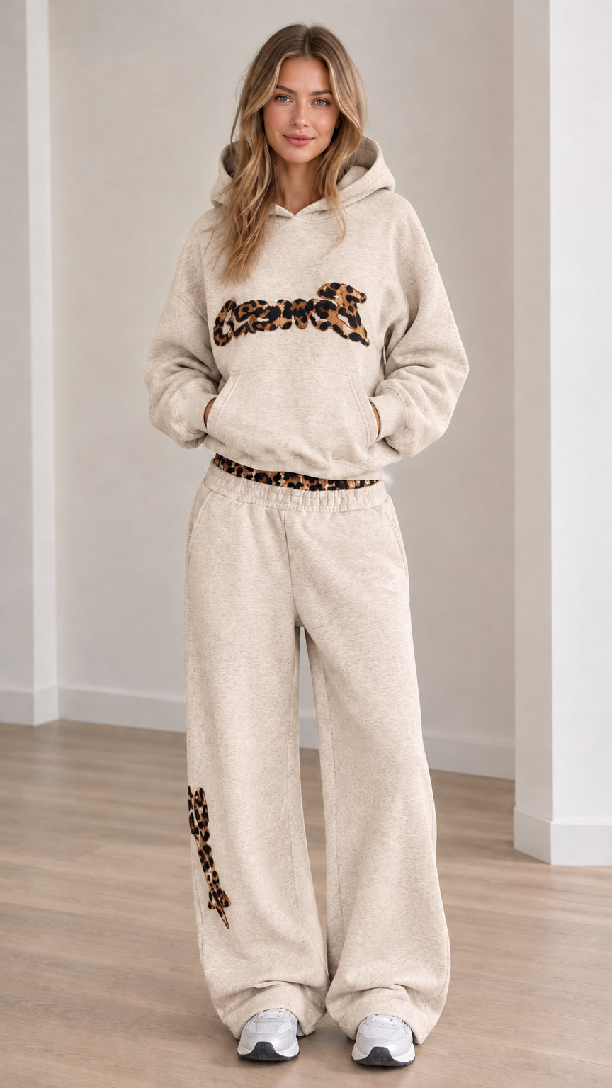 Front view of model wearing the lounge set in Beige with matching leopard-trimmed hoodie and pants