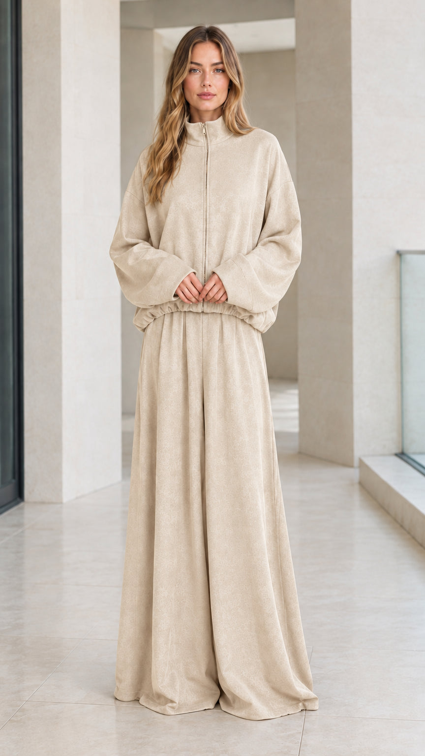Front view of woman wearing neutral beige zip-up jacket and wide-leg lounge pants