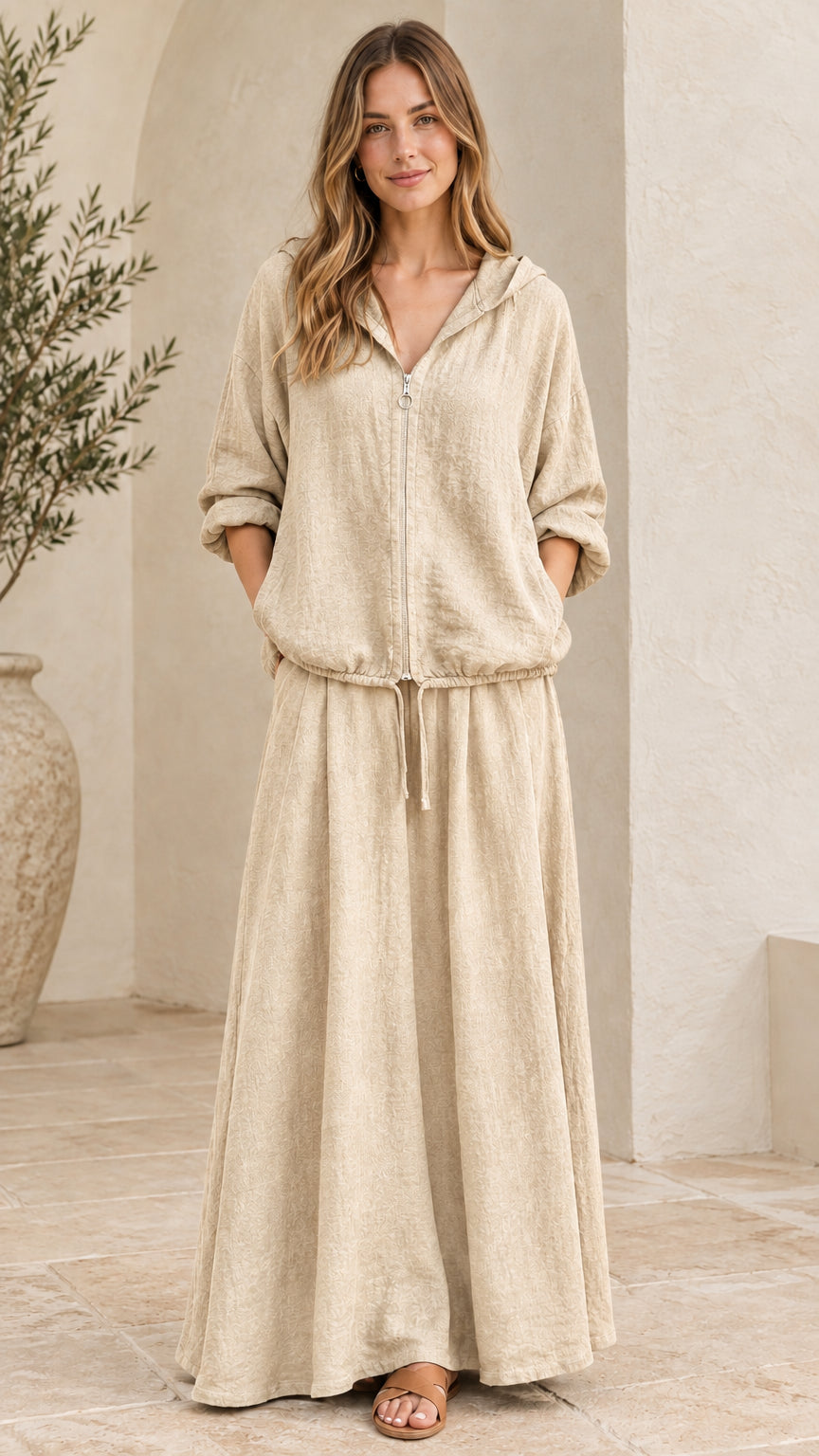Front view of woman wearing beige oatmeal hooded top and maxi skirt set