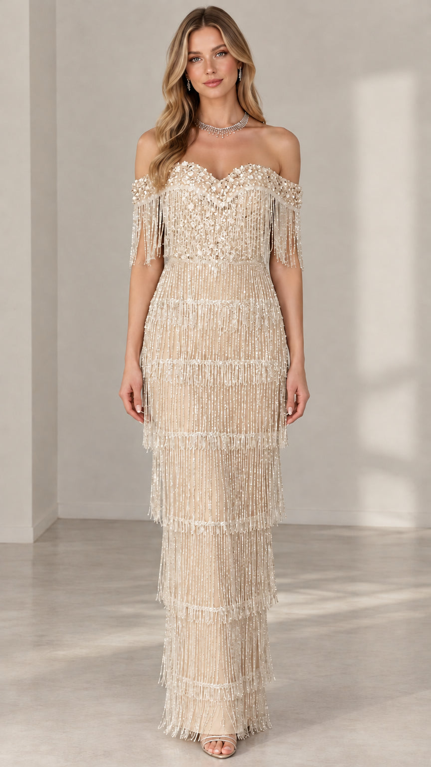 Model wearing champagne gold off-the-shoulder sequin beaded fringe floor-length gown