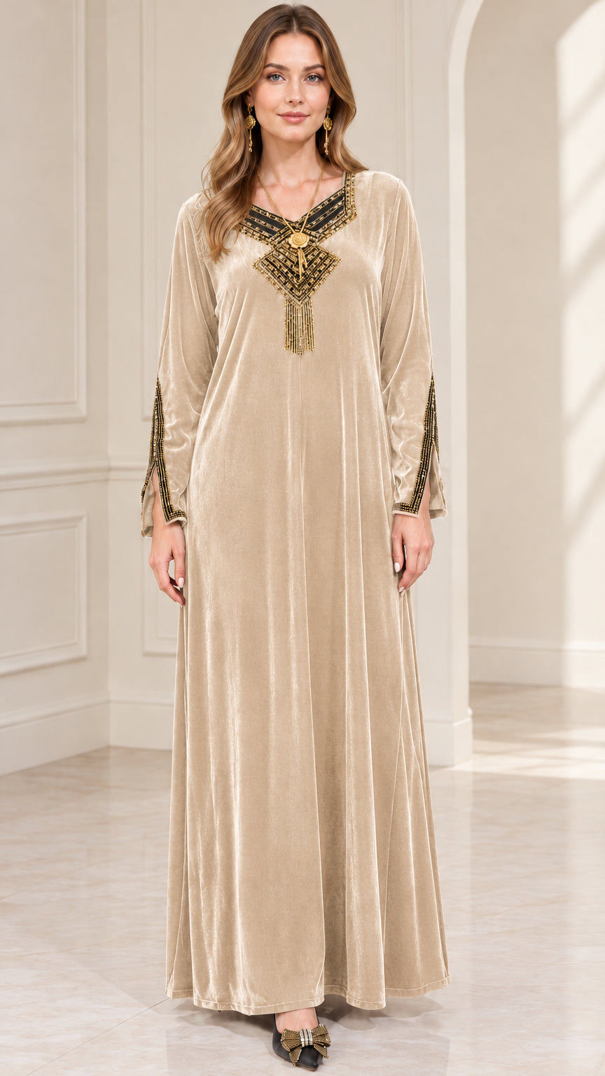 Front view of woman wearing champagne gold embroidered velvet maxi dress
