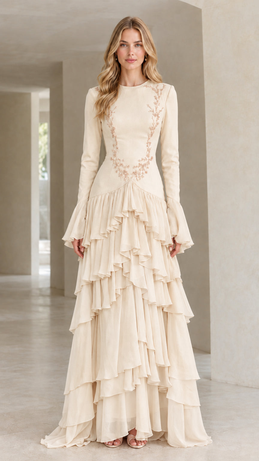 Front full view of woman wearing champagne cream embroidered tiered ruffle long sleeve gown