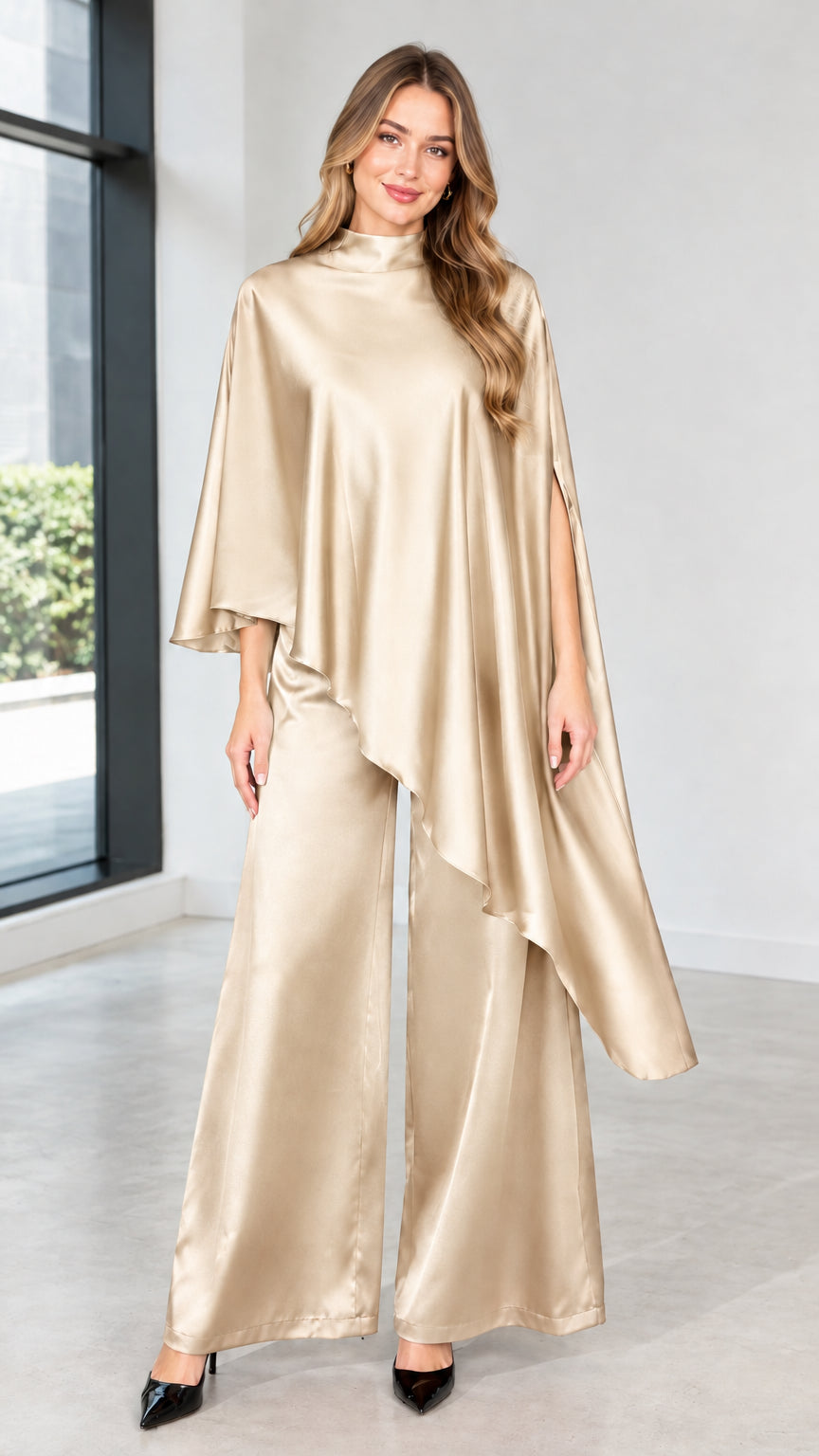 Model wearing champagne gold satin high-neck capelet top and elegant wide-leg trousers