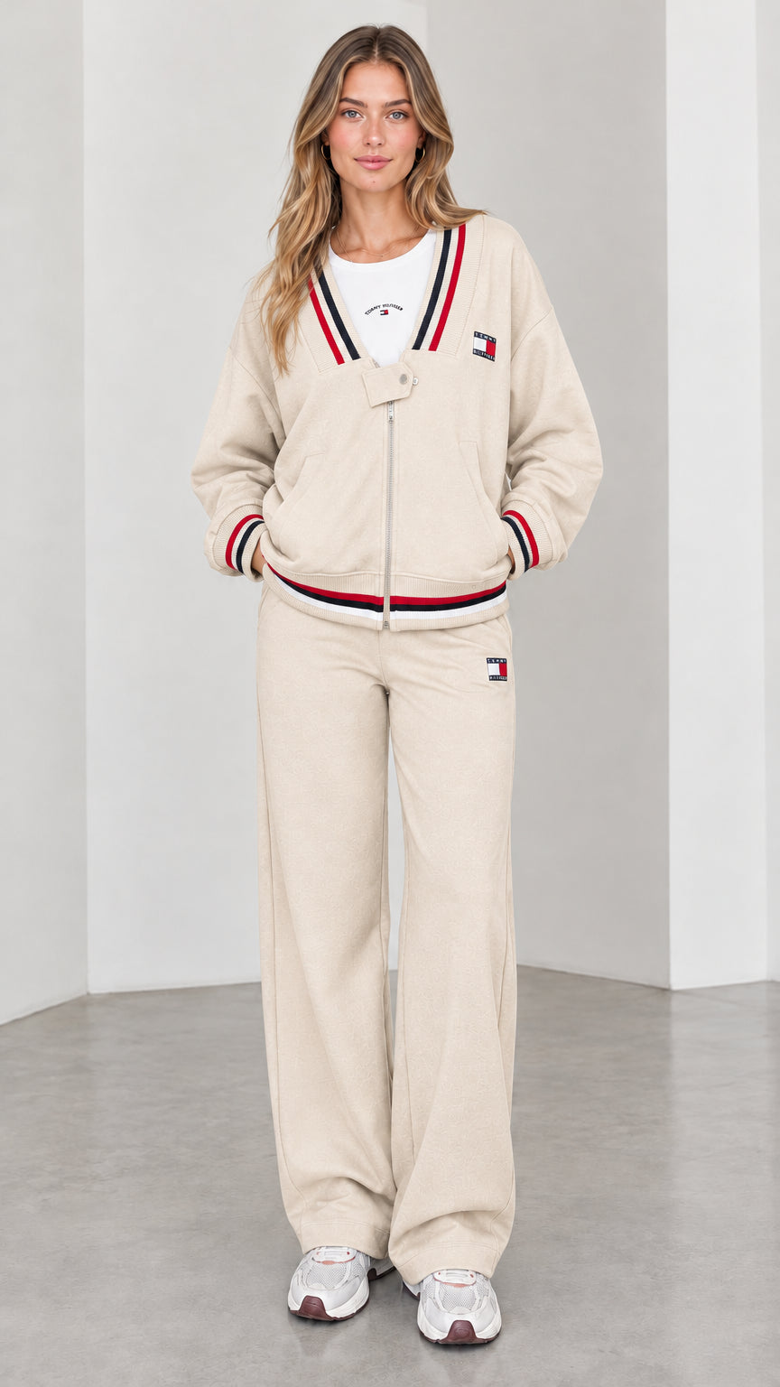 Front view of model wearing beige cream varsity striped tracksuit set